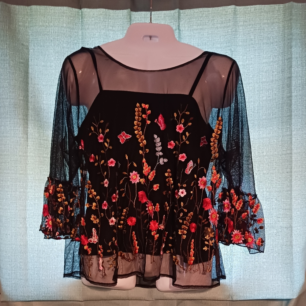 Mesh like top with floral design attached camisole top underneath.
